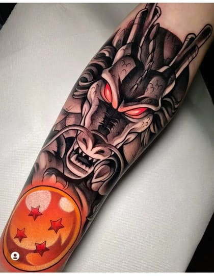 Tatuagem de Shenron, o dragão de Dragon Ball, com olhos vermelhos e uma Esfera do Dragão laranja no antebraço, estilo anime e neo traditional.
